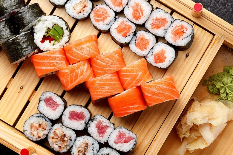 Assorted sushi pieces on bamboo mat